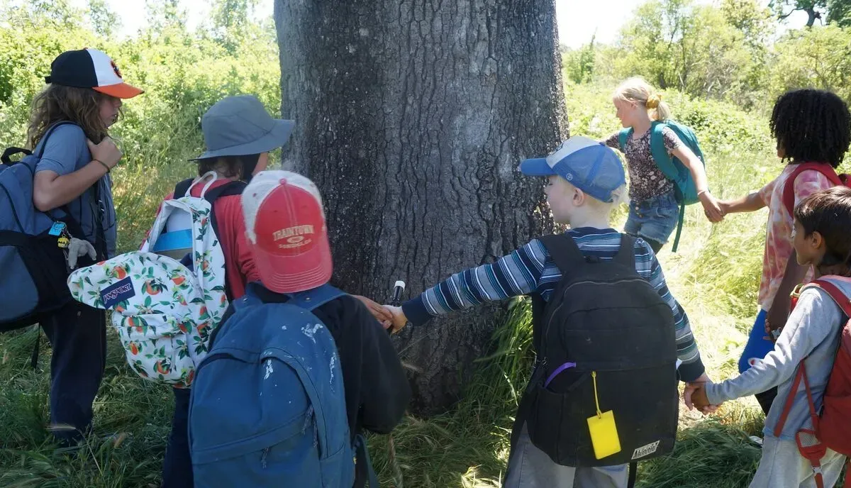 Children gathered outdoors at BeeHive Land-Based Learning Center